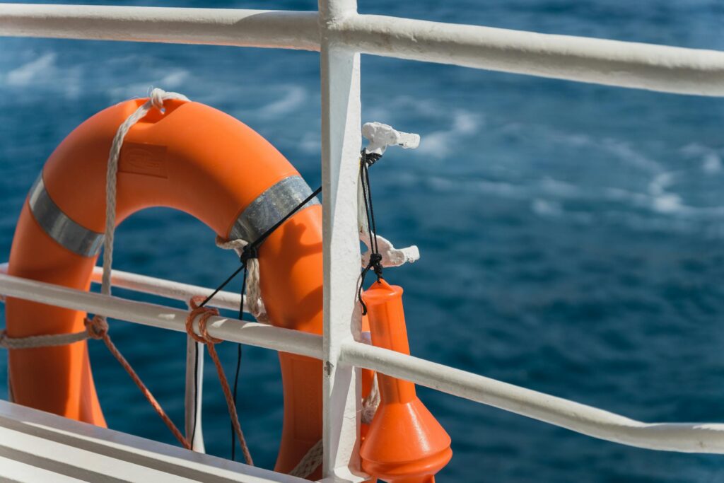 Close-up of a lifebuoy on a ship's railing against the blue ocean in Croatia.